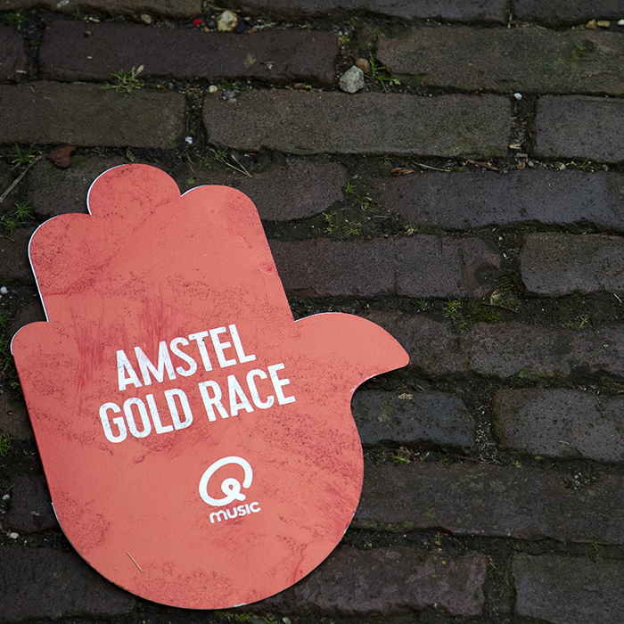 Amstel Gold Race 2023 - Amstel Gold Race red hand merchandise left behind by the caravan on the cobbles of the Maasberg