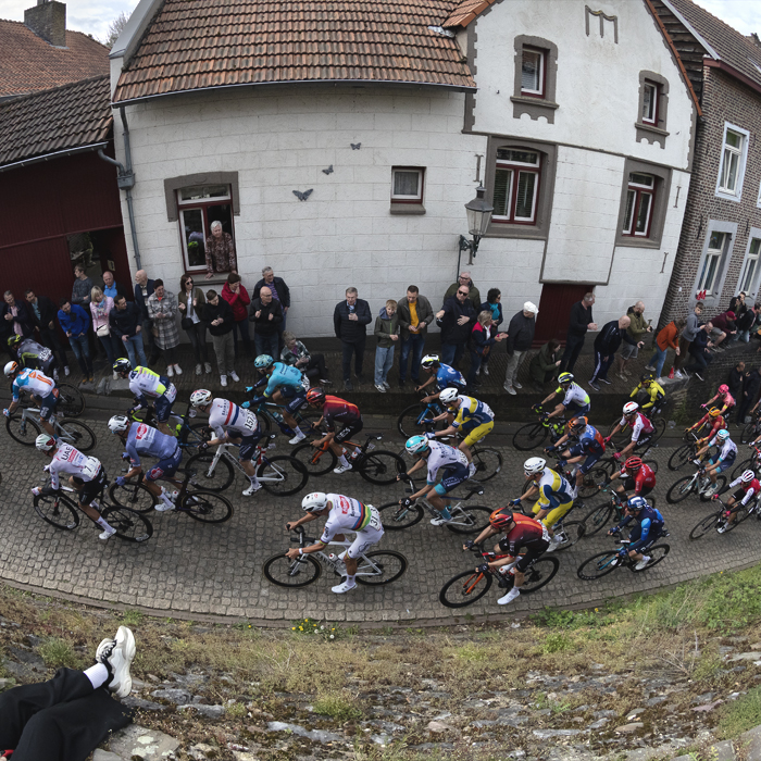 Amstel Gold Race 2024 - Traditional buildings on the Maasberg with Mathieu van der Poel among the riders