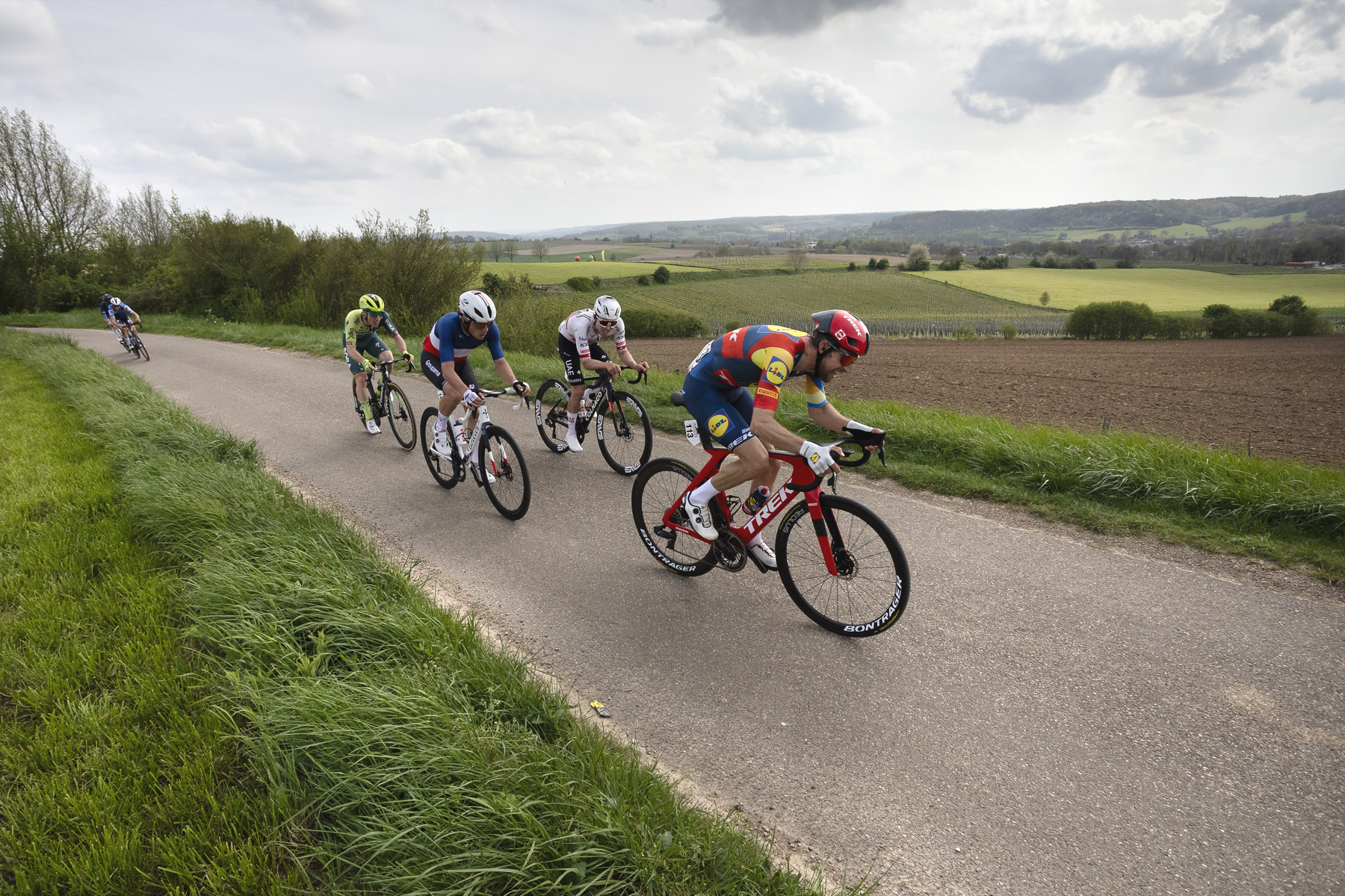 Amstel Gold Race 2024 - Bauke Mollema of Lidl - Trek leads a group of riders past an open view on Schaapsdries