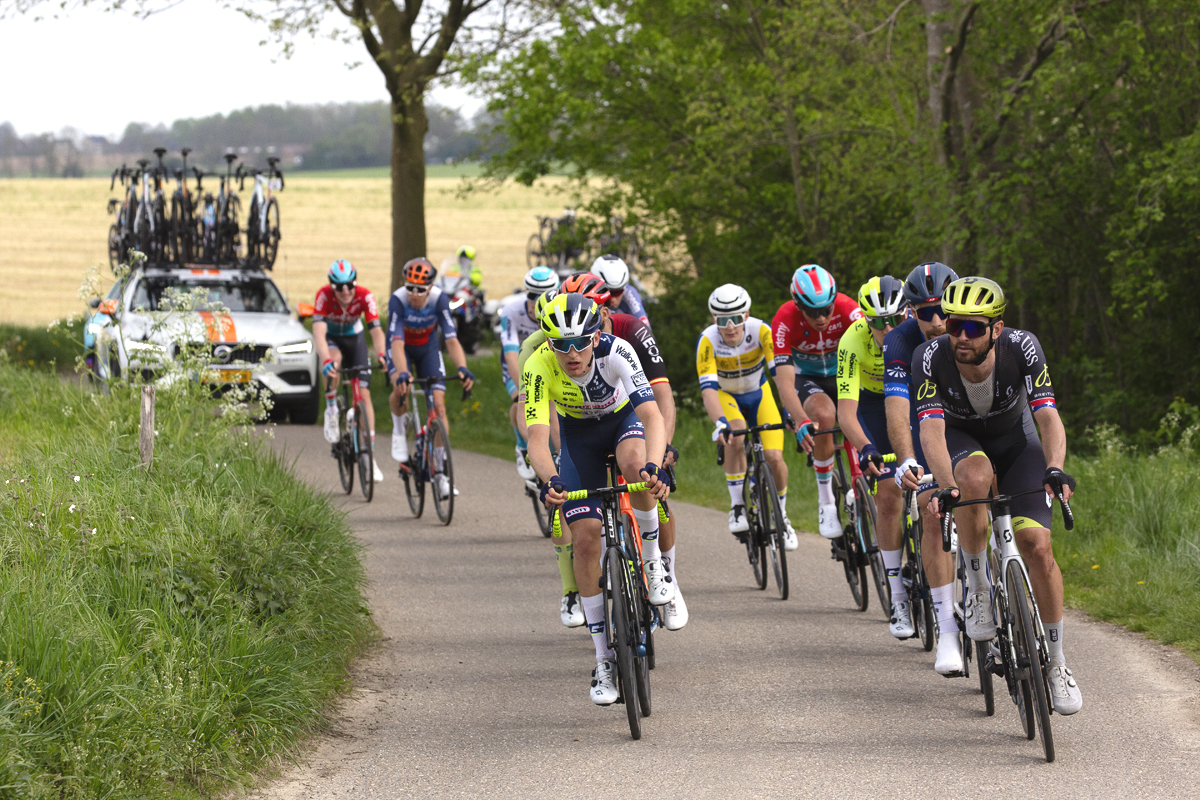 Amstel Gold Race 2024 - Riders on Schaapsdries pass verges with wildflowers