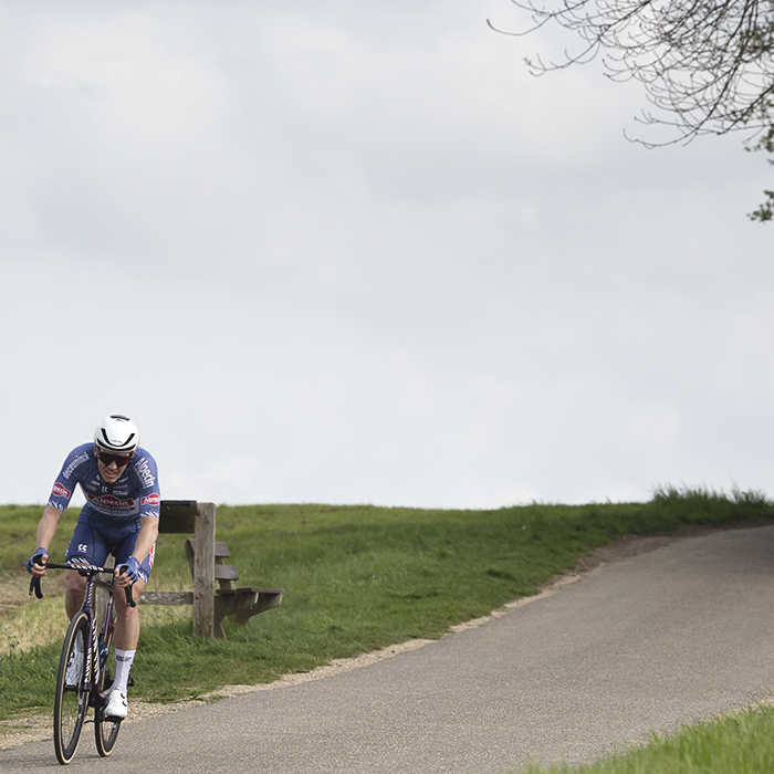 Amstel Gold Race 2024 - Søren Kragh Andersen of Alpecin - Deceuninck is chased down by a group of riders on the horizon.