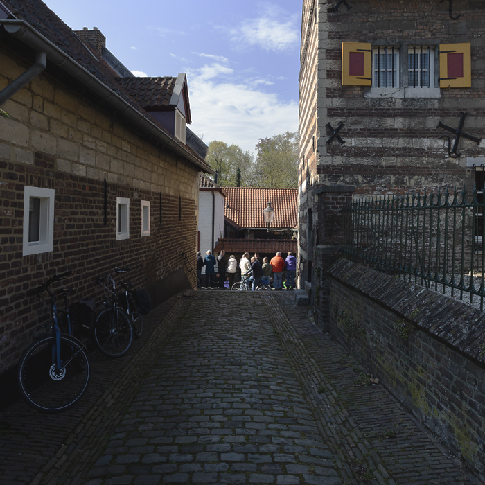 Amstel Gold Race 2025 - A bike is leans against a wall as the Maasberg can be seen looking down a cobbled side street