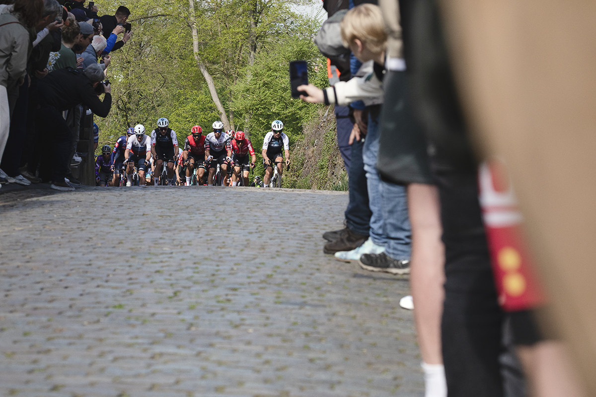 Amstel Gold Race 2025 - A young fan films the race as the riders approach up the Maasberg
