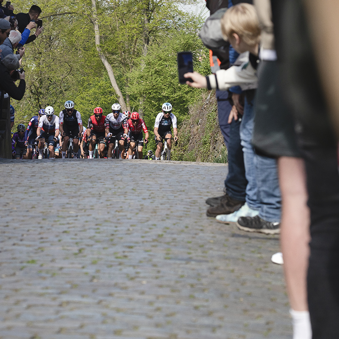 Amstel Gold Race 2025 - A young fan films the race as the riders approach up the Maasberg