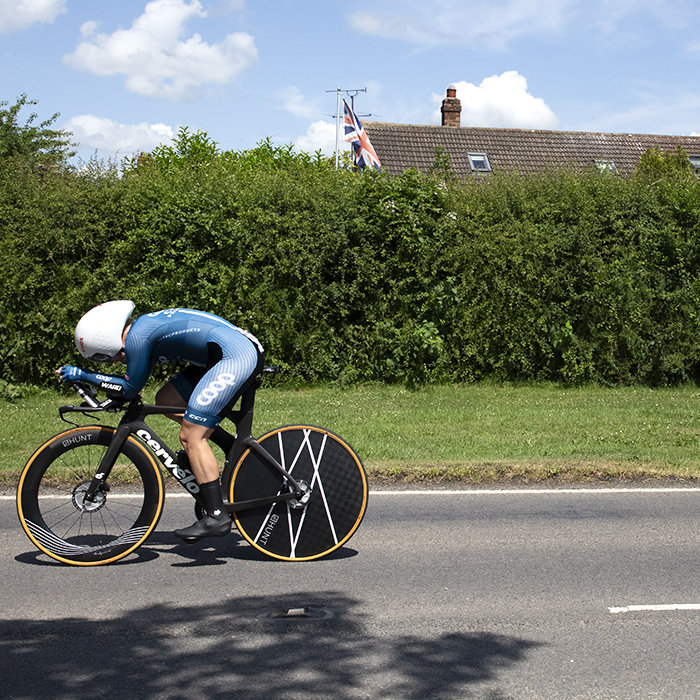 British National Road Championships 2023 - Women’s Time Trial - Jessica Roberts of Team Coop-Hitec Products passes a women pushing a pram during the competition