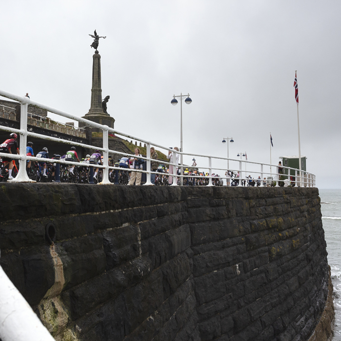 British National Road Championships 2025 - Road Race - Men - Aberystwyth - the race rolls out past an obelisk with a statue on the top