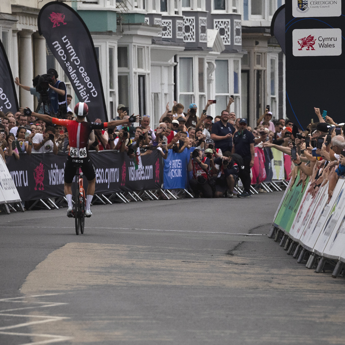 British National Road Championships 2025 - Road Race - Men - Sam Watson of Ineos Grenadiers raises his arms as he is seen from the rear winning the race