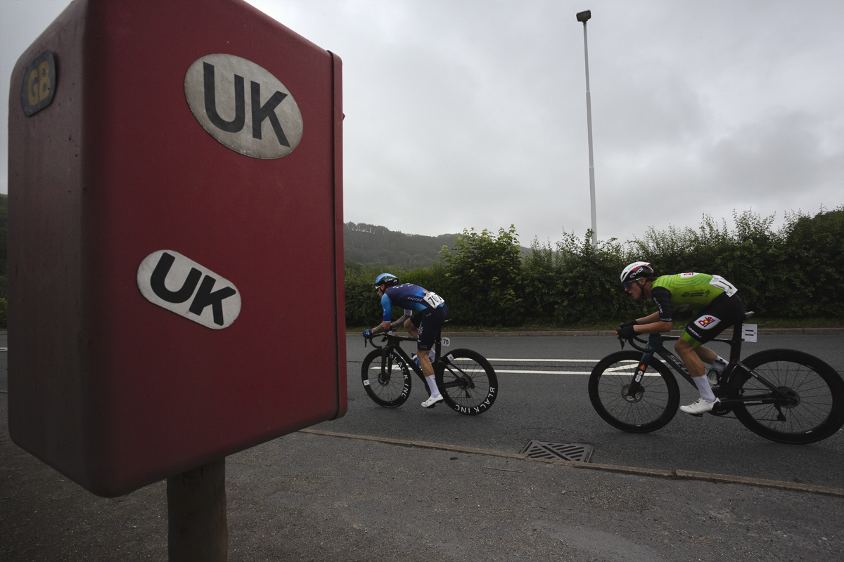British National Road Championships 2025 - Road Race - Men - Jake Stewart of Israel - Premier Tech & Jack Brough of AVC Aix en Provence race past a post box covered in UK and GB car stickers