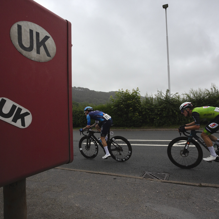 British National Road Championships 2025 - Road Race - Men - Jake Stewart of Israel - Premier Tech & Jack Brough of AVC Aix en Provence race past a post box covered in UK and GB car stickers