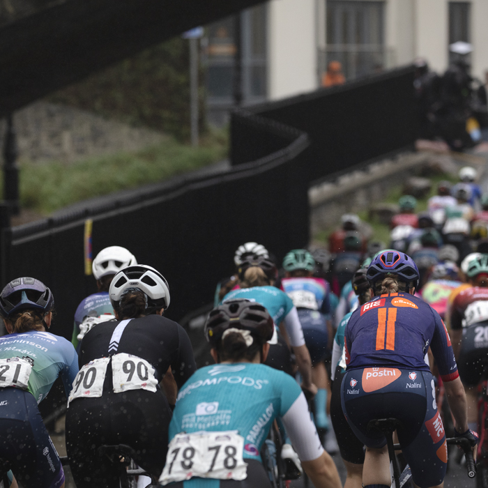 British National Road Championships 2025 - Road Race - Women - Aberystwyth - rear view of the riders with a set of railings snaking away to their left