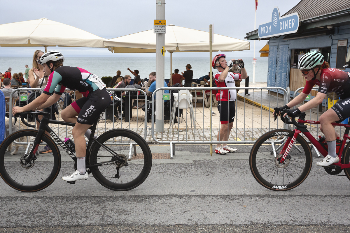 British National Road Championships 2025 - Road Race - Women - A fan lifts his phone to line up a shot of Lotty Dawson of Brother UK - On Form & Alice Colling of Smurfit Westrock Cycling Team