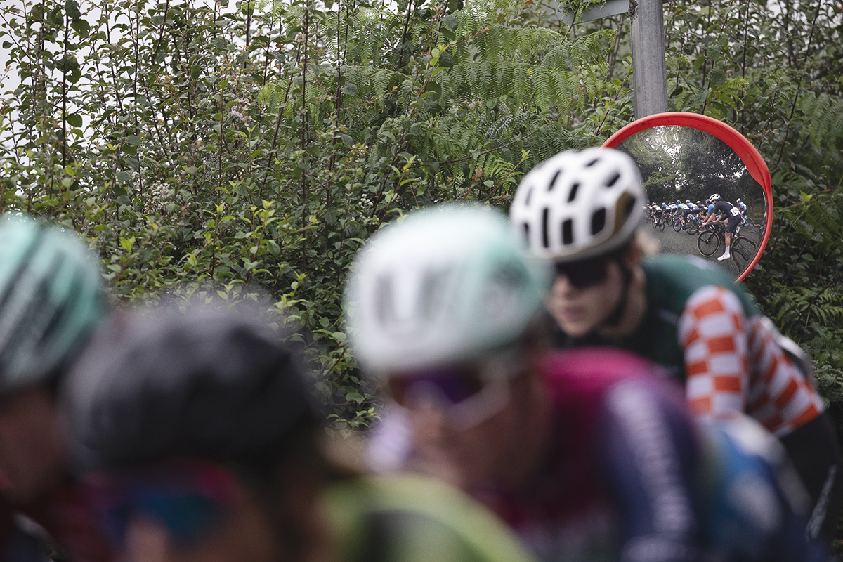 British National Road Championships 2025 - Road Race - Women - Rhydyfelin - riders are reflected in a roadside mirror