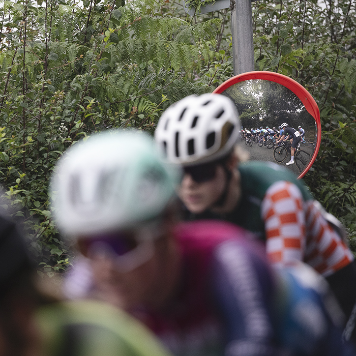 British National Road Championships 2025 - Road Race - Women - Rhydyfelin - riders are reflected in a roadside mirror