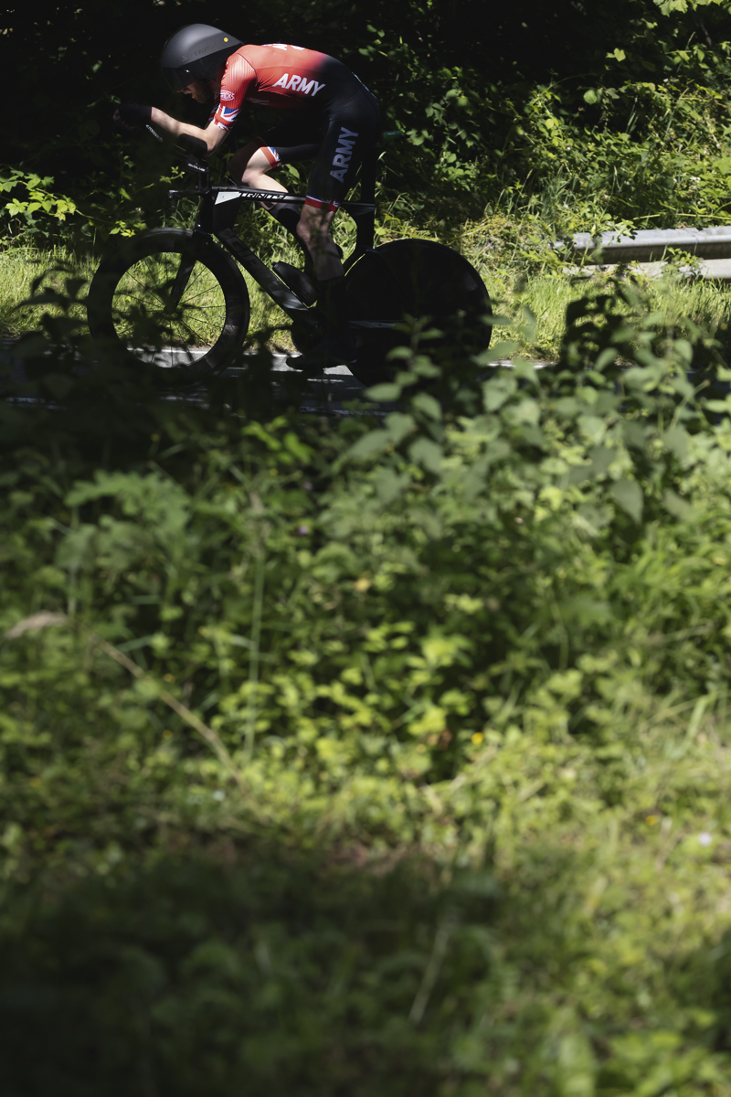 British National Road Championships 2025 - Time Trial - Elite Men - patches of light illuminate Jimmy Smith of Army Cycling Union as he rides through the countryside