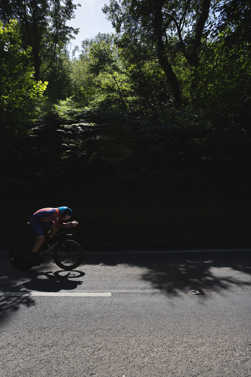 British National Road Championships 2025 - Time Trial - Elite Men - Matthew Rossiter of George Fox Cycling Solutions rides out of the shade of the trees and into a patch of light
