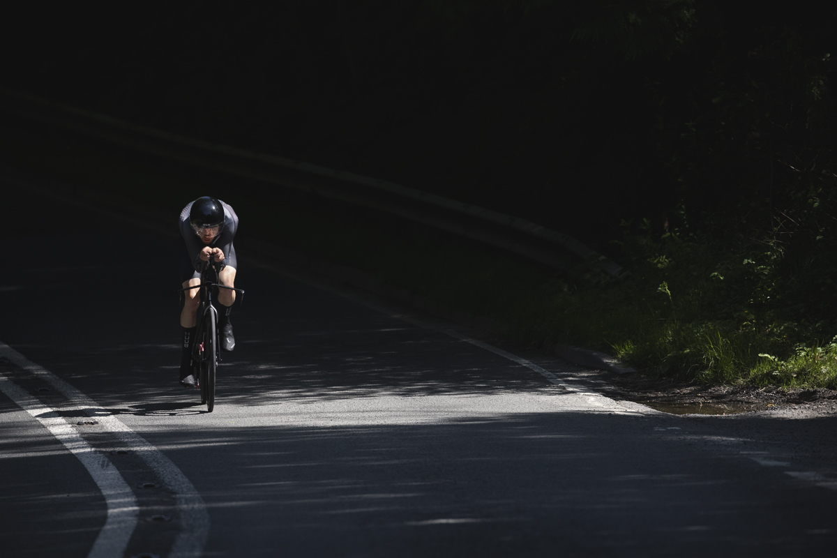British National Road Championships 2025 - Time Trial - Elite Men - Toby Tanfield of Leadout Performance rides through the mottled light on the road
