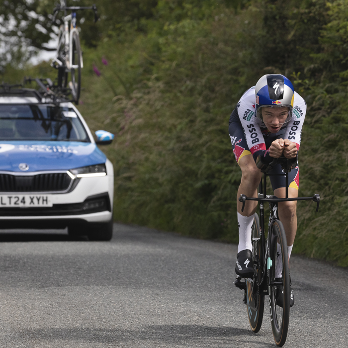 British National Road Championships 2025 - Time Trial - U23 Men - Callum Thornley of Red Bull - BORA - hansgrohe Rookies followed by a team car as he rides on small country roads