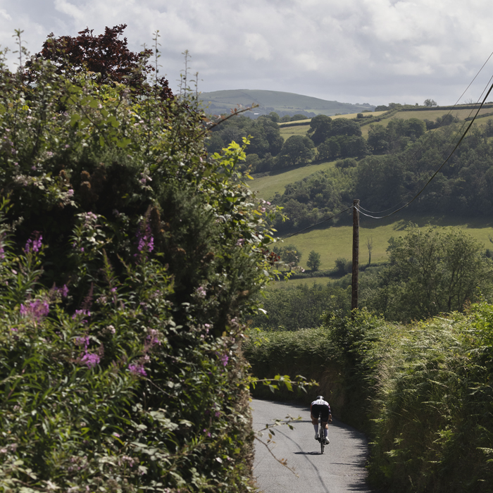 British National Road Championships 2025 - Time Trial - Elite Women - Charlotte Hodgkins-Byrne passes through the rolling hills of the countryside outside Aberaeron