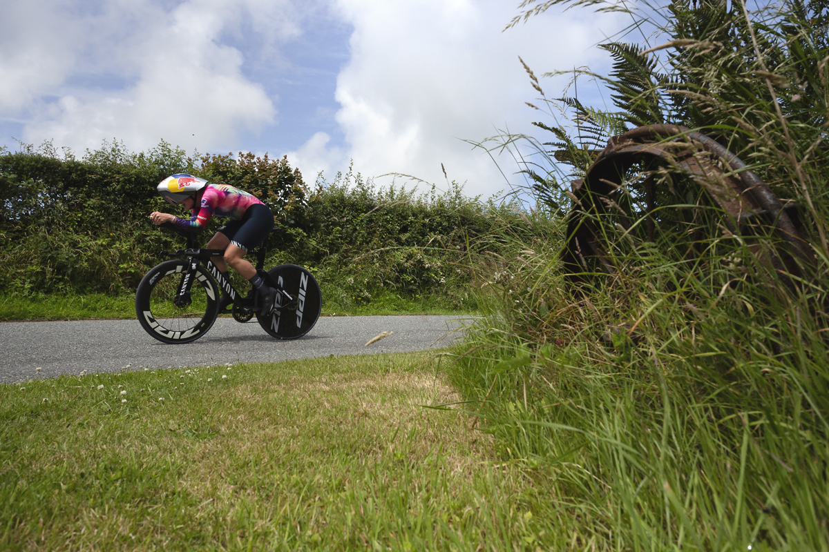 British National Road Championships 2025 - Time Trial - Elite Women - Zoe Bäckstedt passes a gate end with the remnants of old farm machinery