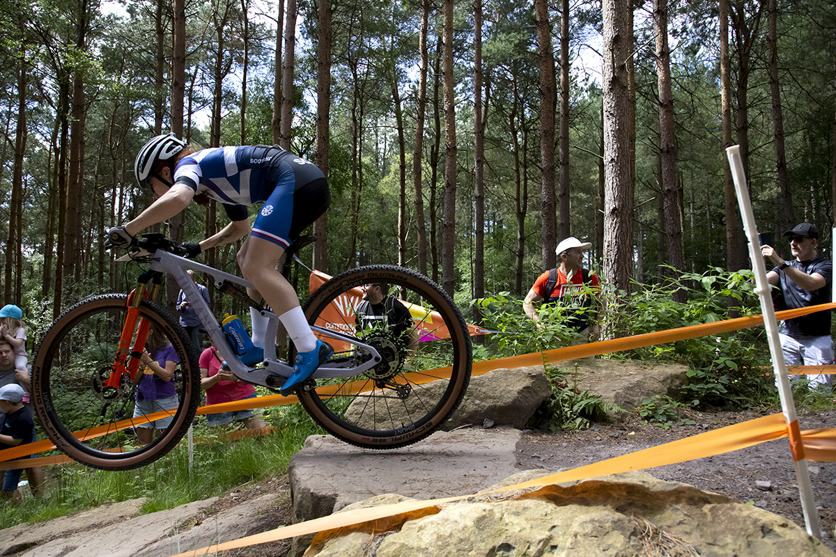 Birmingham 2022 - XXII Commonwealth Games - Mountain Bike - Women - Nancy Isla Short of Scotland jumps from a rocky outcrop