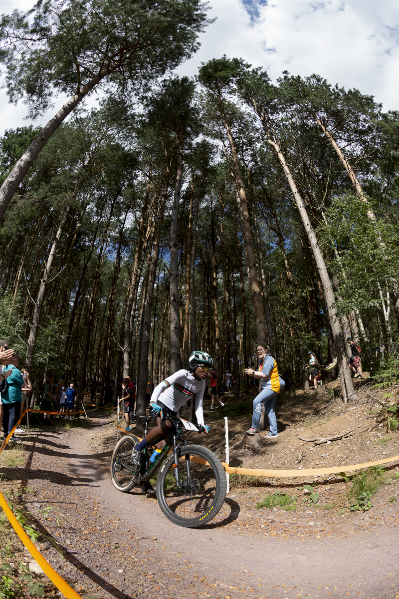 Birmingham 2022 - XXII Commonwealth Games - Mountain Bike - Women - Nancy Akinyi Debe of Kenya races into a sunlit glade