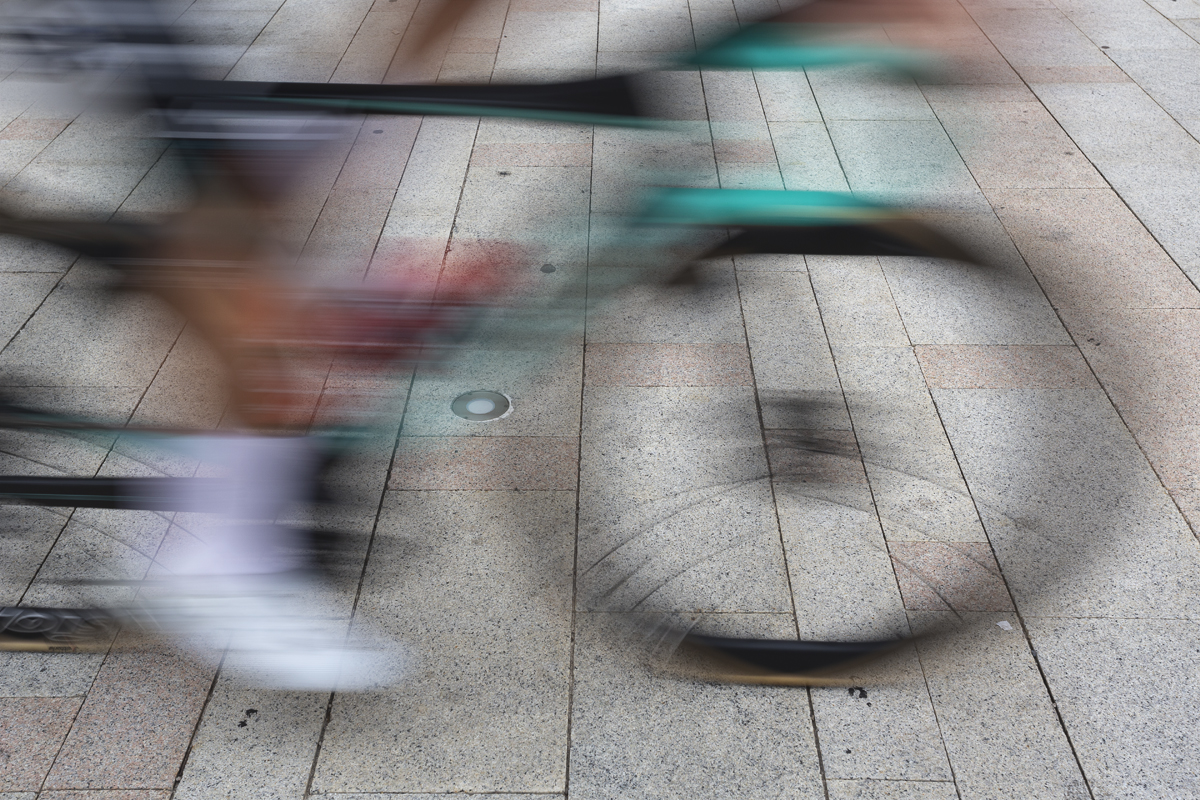 Coppa Bernocchi 2024 - A bike speeds by on the piazza of Legnano