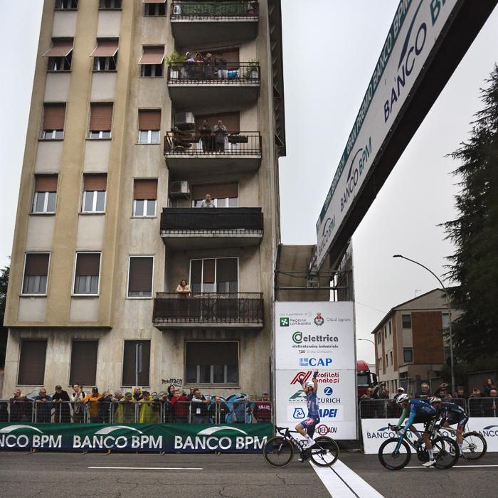 Coppa Bernocchi 2024 - A side view of Stan Van Tricht crossing the line victorious with a block of flats in the background