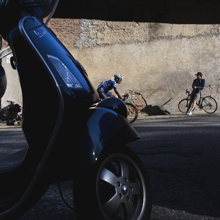 Coppa Bernocchi 2025 - Ethan Hayter is framed by a Vespa moped as he takes on the lower slopes of a climb