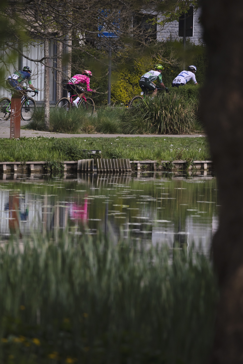 De Brabantse Pijl 2025 - Riders reflected in an ornamental lake on the outskirts of Overijse