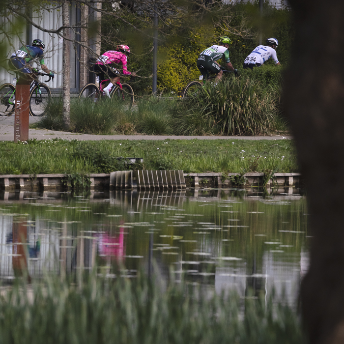 De Brabantse Pijl 2025 - Riders reflected in an ornamental lake on the outskirts of Overijse