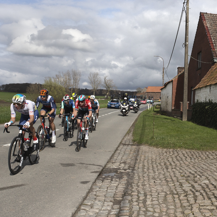 Dwars Door Vlaanderen 2024 - A group of riders race down Chau de Renaix