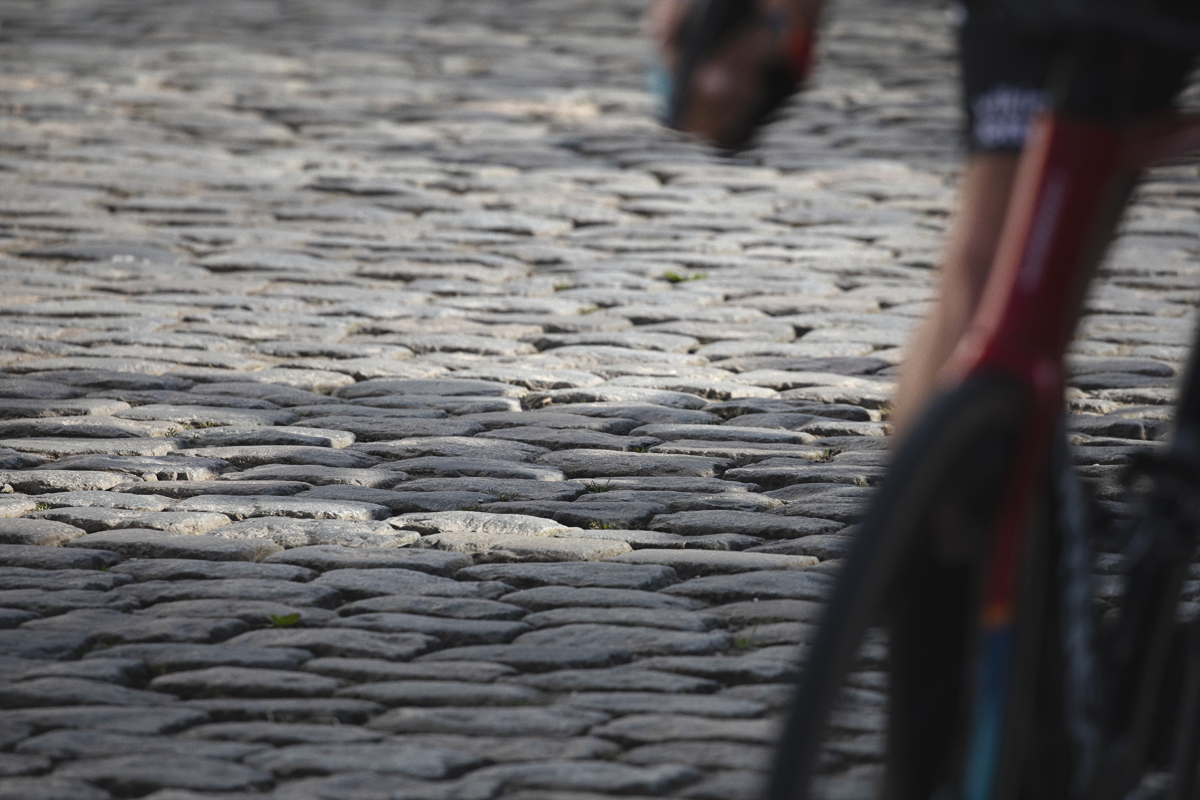 Dwars Door Vlaanderen 2024 - A close up of the cobbles on Nokereberg with a bike in the foreground