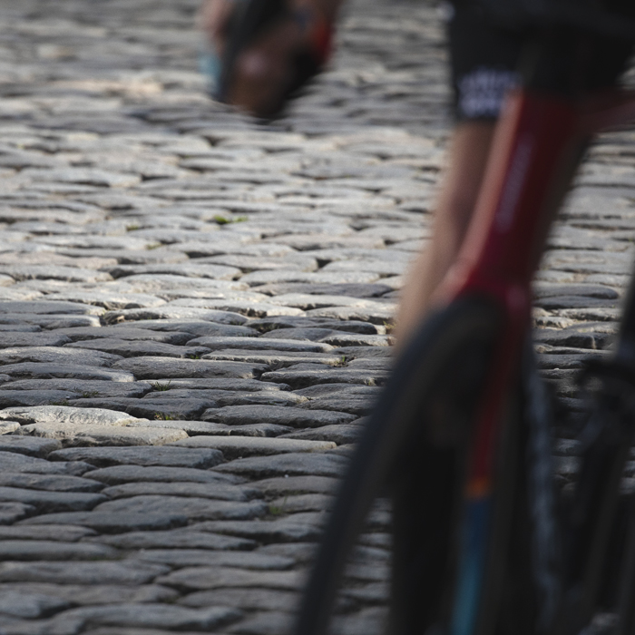 Dwars Door Vlaanderen 2024 - A close up of the cobbles on Nokereberg with a bike in the foreground