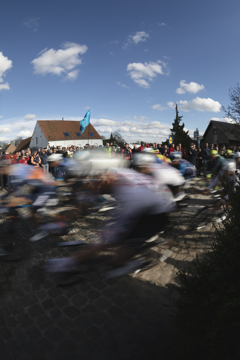 Dwars Door Vlaanderen 2024 - Riders speed round a corner in Nokere