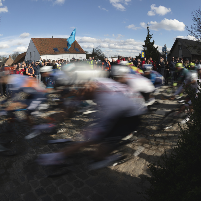 Dwars Door Vlaanderen 2024 - Riders speed round a corner in Nokere