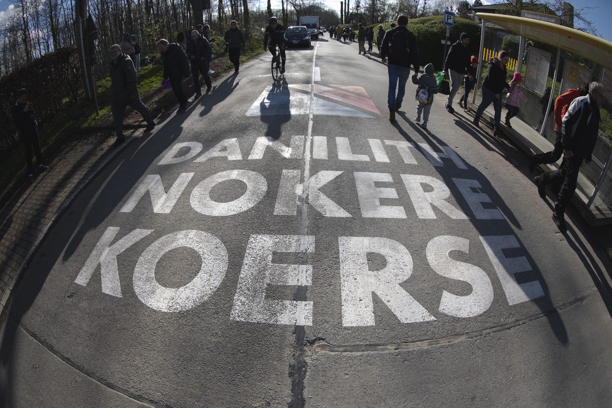 Dwars Door Vlaanderen 2024 - The logo for another race, Danlith Nokere Koerse painted on the road in Nokere