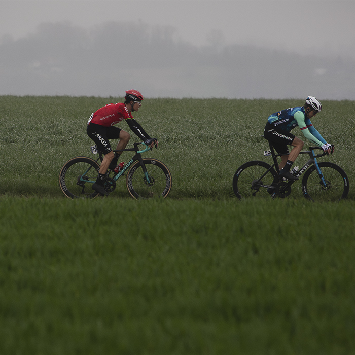 E3 Saxo Classic 2024 - Edvald Boasson Hagen and Miles Scotson seen on Aaste Heerweg with open fields in the foreground