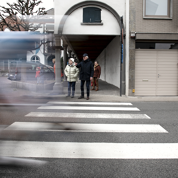 E3 Saxo Classic 2024 - An elderly couple watch as a rider speeds past