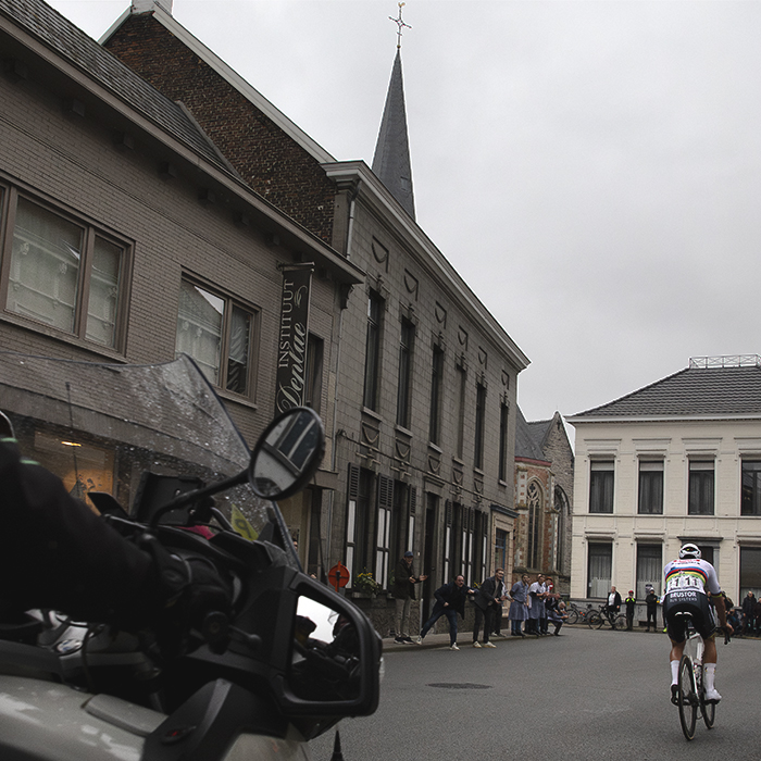 E3 Saxo Classic 2024 - Mathieu van der Poel seen from behind as he races solo through the streets of Kluisbergen