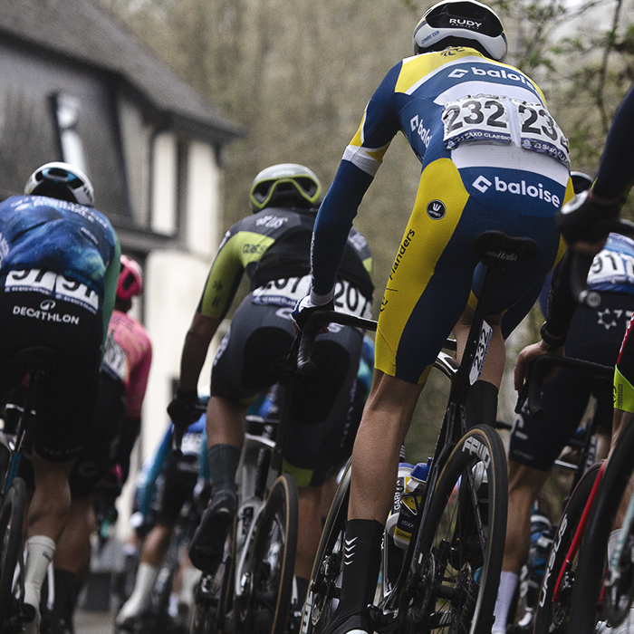 E3 Saxo Classic 2024 - The peloton moves off down rijkswachtdreef