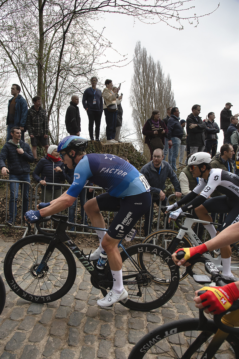 E3 Saxo Classic 2025 - Matis Louvel in a group of riders is watched by fans on the high banks next to the road