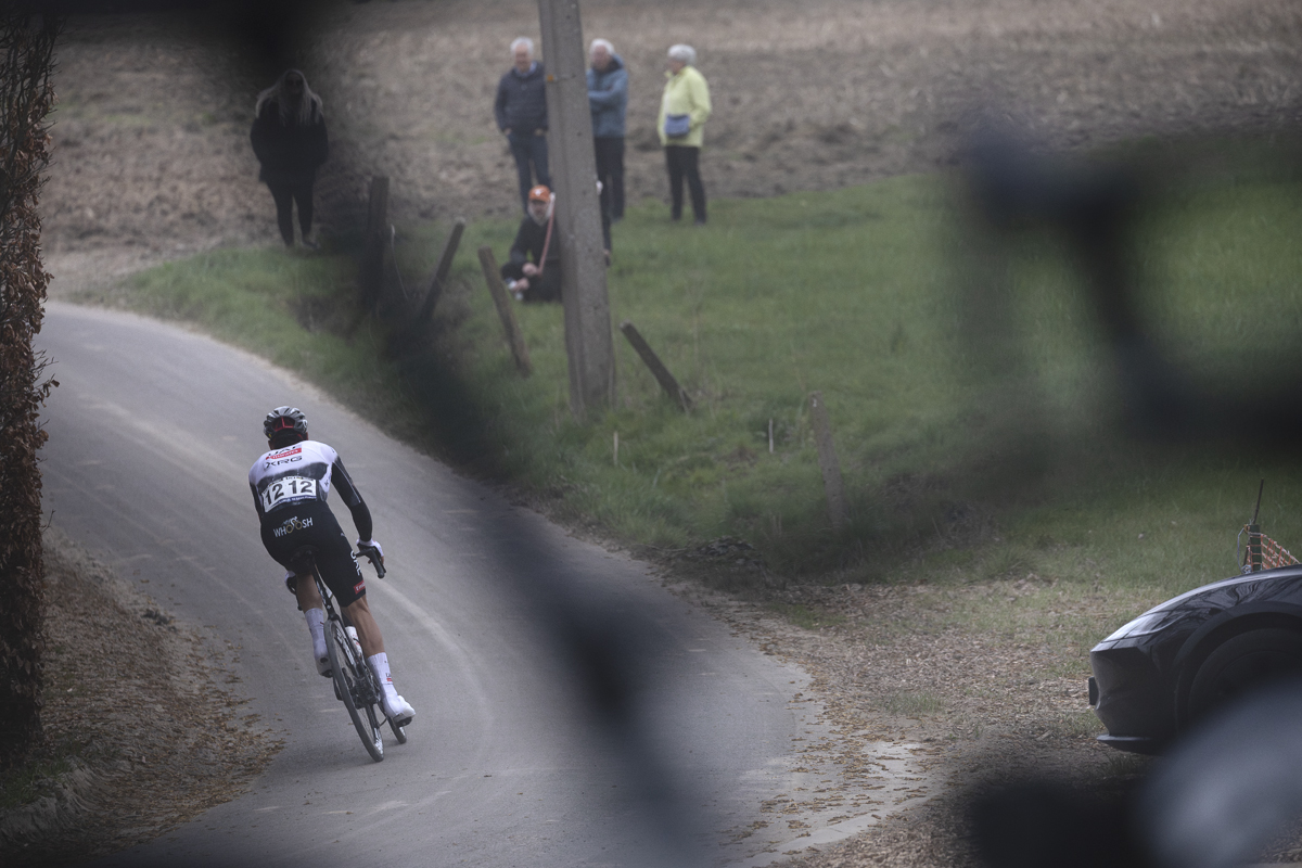 E3 Saxo Classic 2025 - Filippo Baroncini is framed by a bike frame on top of a team car