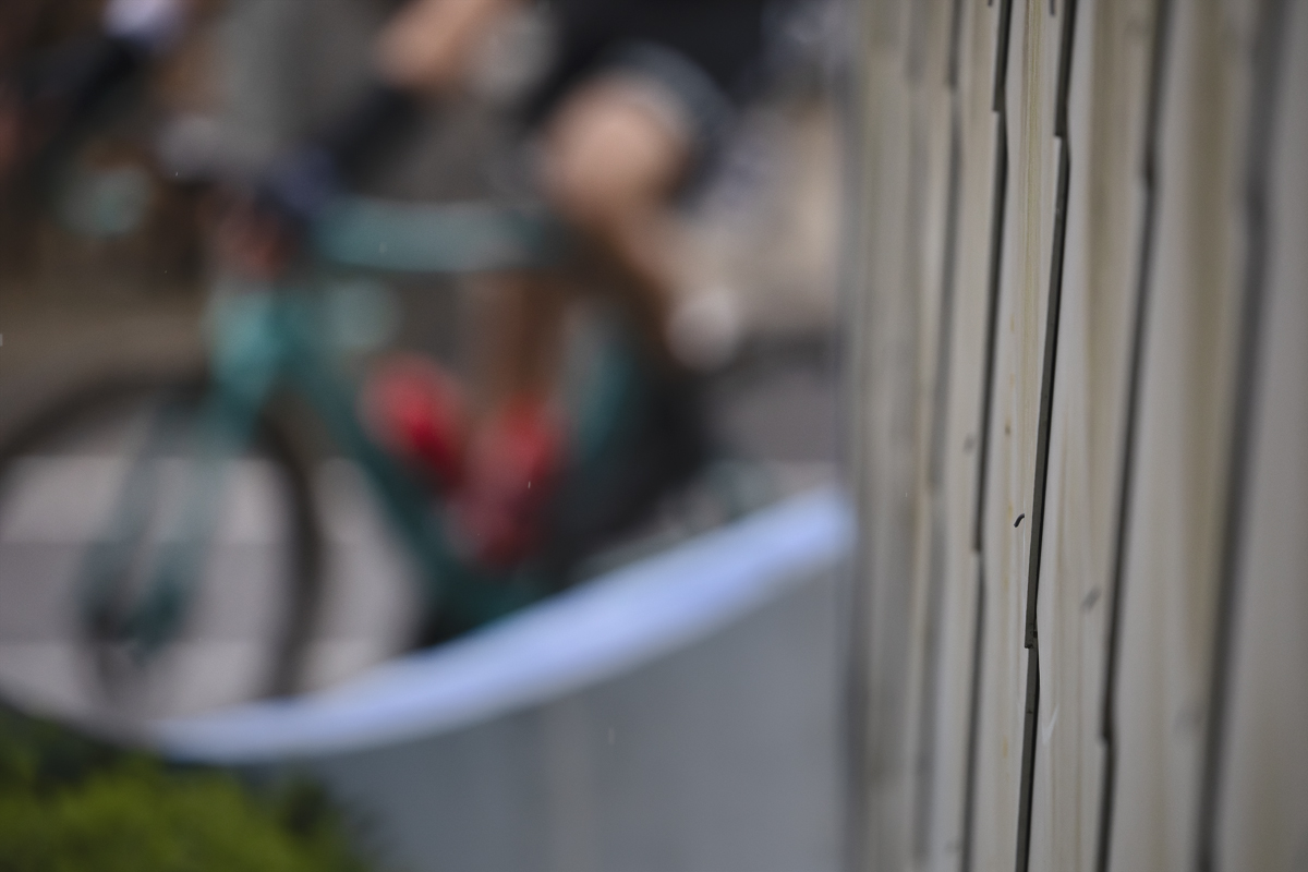 E3 Saxo Classic 2025 - The suggestion of a rider is framed by a building