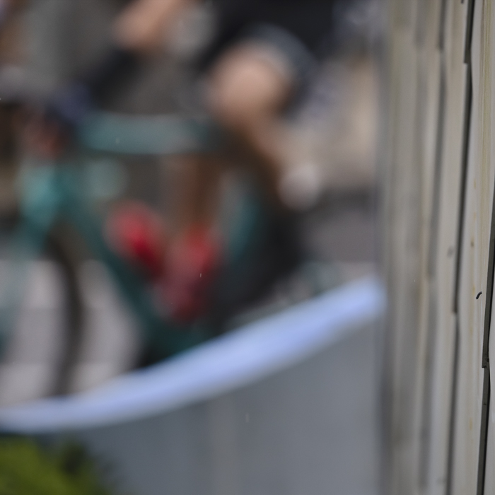 E3 Saxo Classic 2025 - The suggestion of a rider is framed by a building