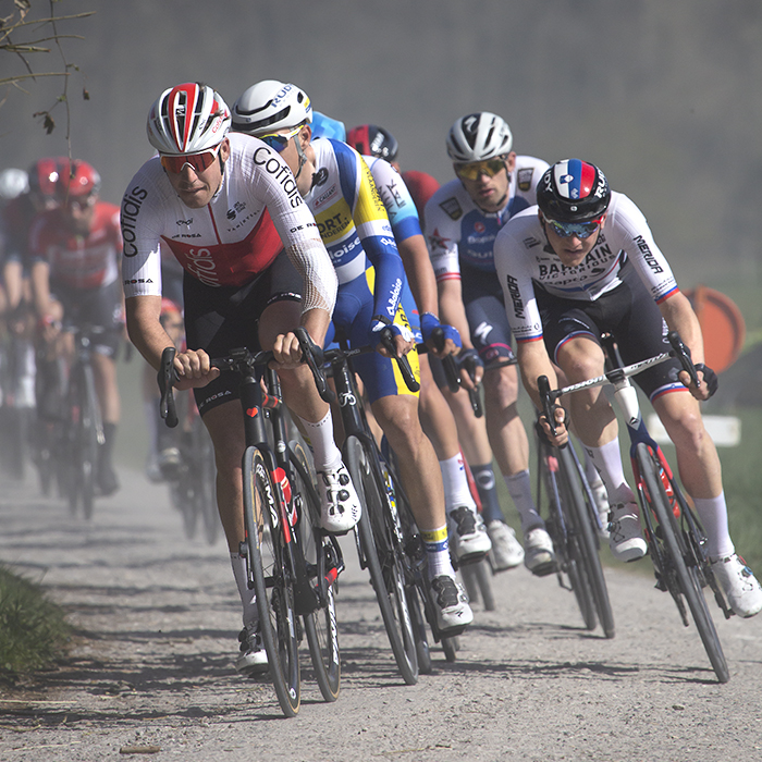 Gent - Wevelgem 2022 - Riders race down one of the Ploegstreet’s kicking up white dust