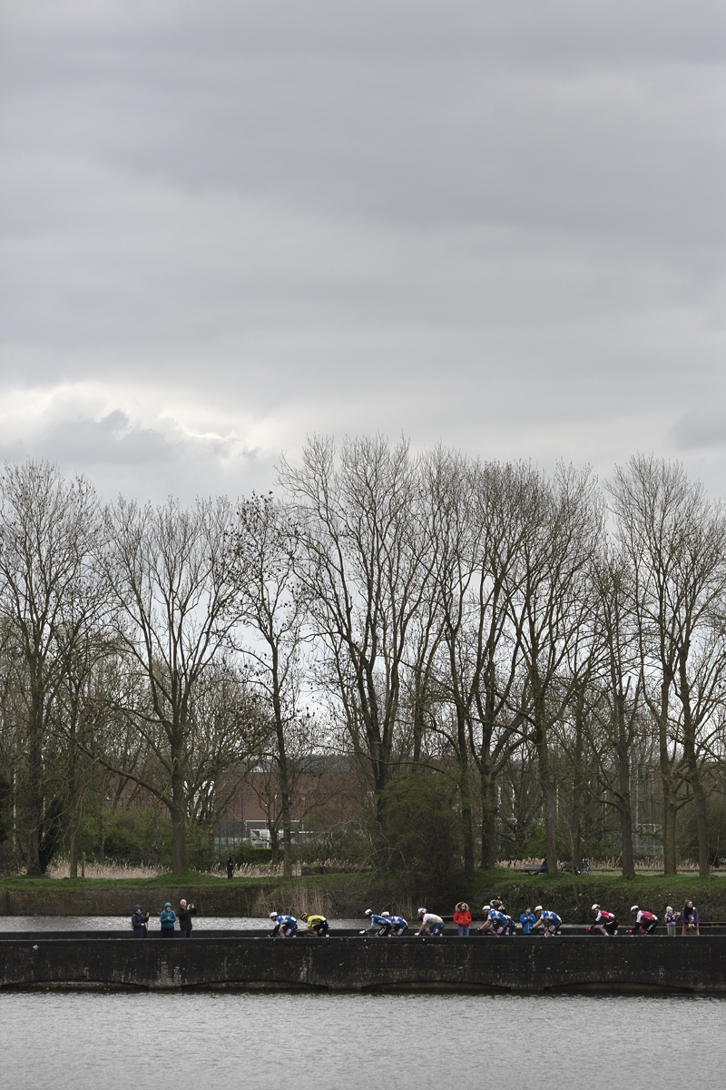 Gent Wevelgem 2024 - Riders seen across the water in Ieper / Ypres