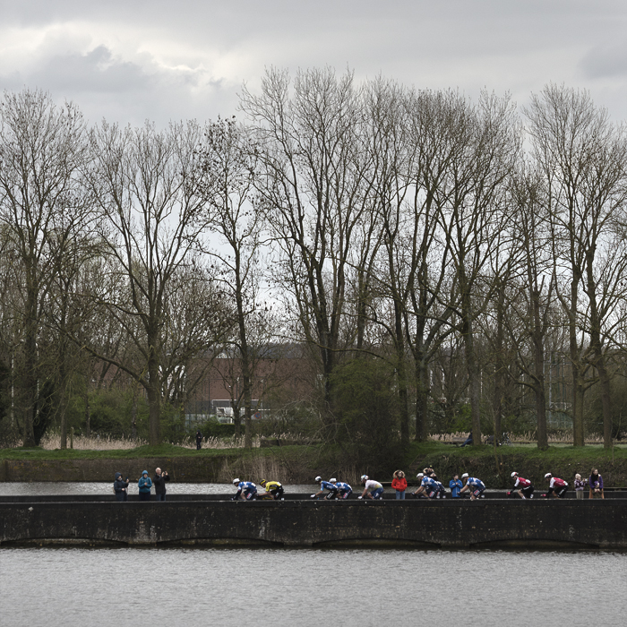 Gent Wevelgem 2024 - Riders seen across the water in Ieper / Ypres