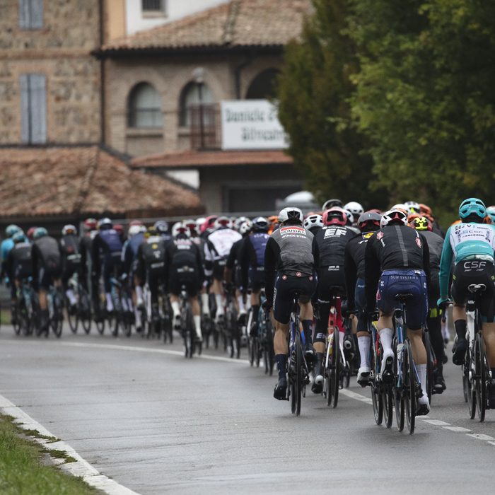 Giro dell’Emilia 2024 - The peloton from the rear clad in rain jackets in Castelvetro
