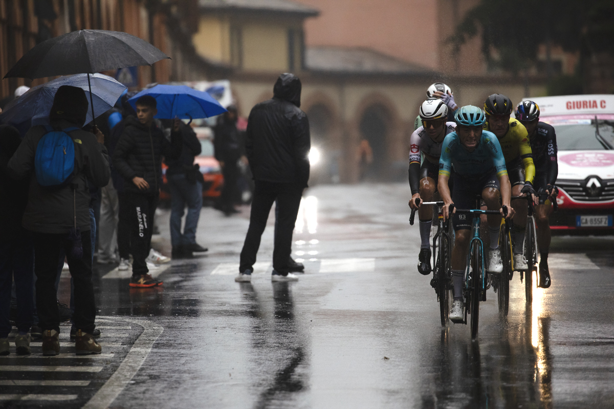 Giro dell’Emilia 2024 - Gianmarco Garofoli of Astana Qazaqstan Team leads a group past fans holding umbrellas
