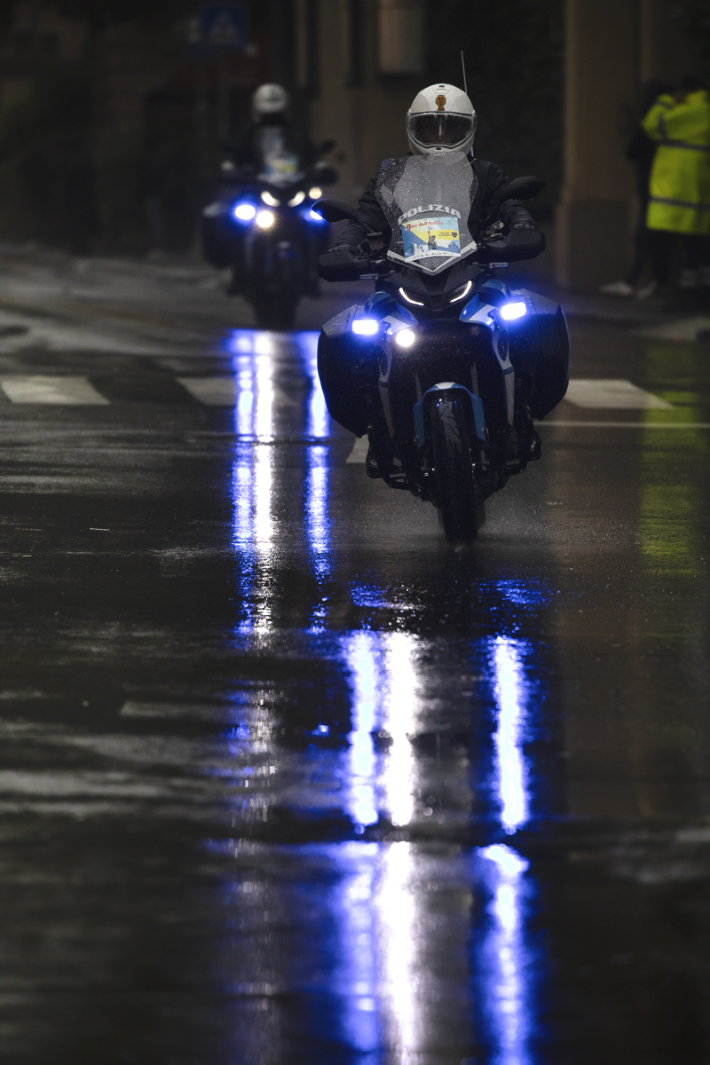 Giro dell’Emilia 2024 - Blue lights of the Polizia reflected in the wet road